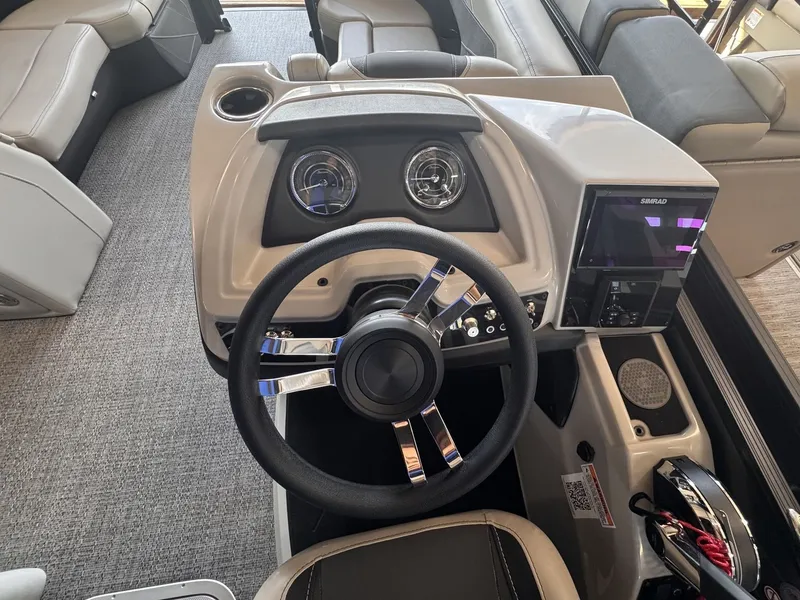Slide: The Image of The image shows the helm of a 2026 Barletta Cabrio 24 UE with a modern steering wheel and instruments. - 13