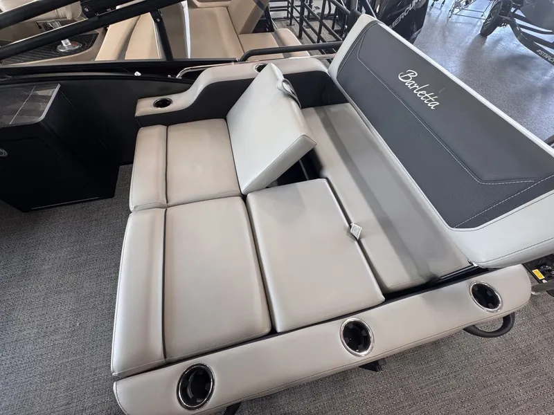 Slide: The Image of The 2026 Barletta Cabrio 24 UE features a luxurious, cushioned bench seat with cup holders. - 26