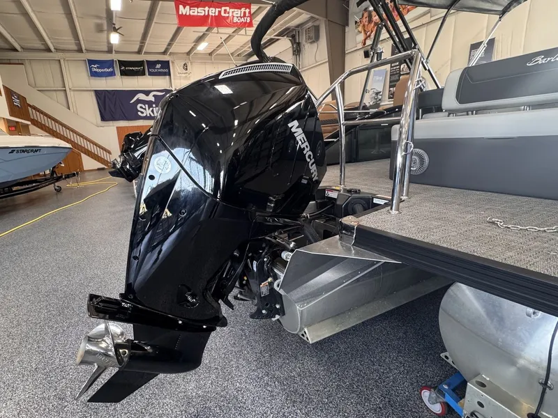 Slide: The Image of A 2026 Barletta Cabrio 24 UE with a Mercury outboard motor in a showroom. - 32