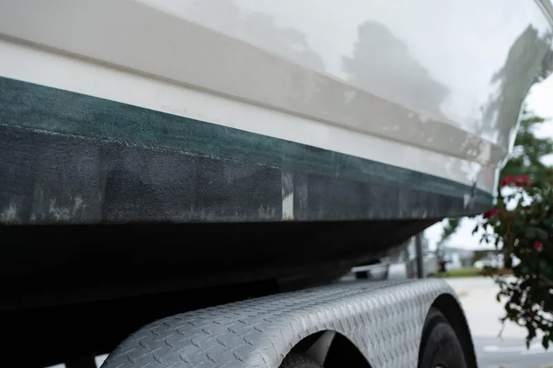 Slide: The Image of Close-up of 2019 Robalo 246 Cayman SD boat hull on trailer. - 18