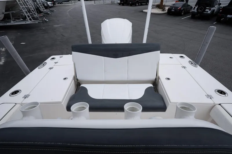 Slide: The Image of 2019 Robalo 246 Cayman SD boat interior with seating and rod holders. - 20
