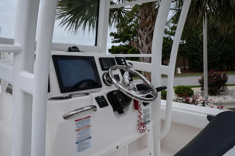Slide: The Image of 2019 Robalo 246 Cayman SD boat console with steering wheel and navigation display. - 26