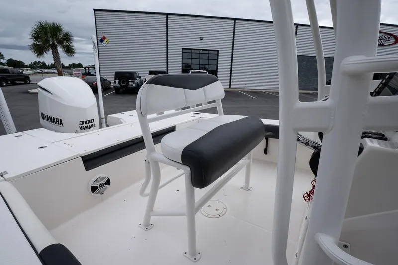 Slide: The Image of 2019 Robalo 246 Cayman SD boat interior with Yamaha 300 engine, docked near a building. - 28