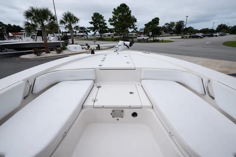 Slide: The Image of 2019 Robalo 246 Cayman SD boat interior with white seating and storage compartments. - 29