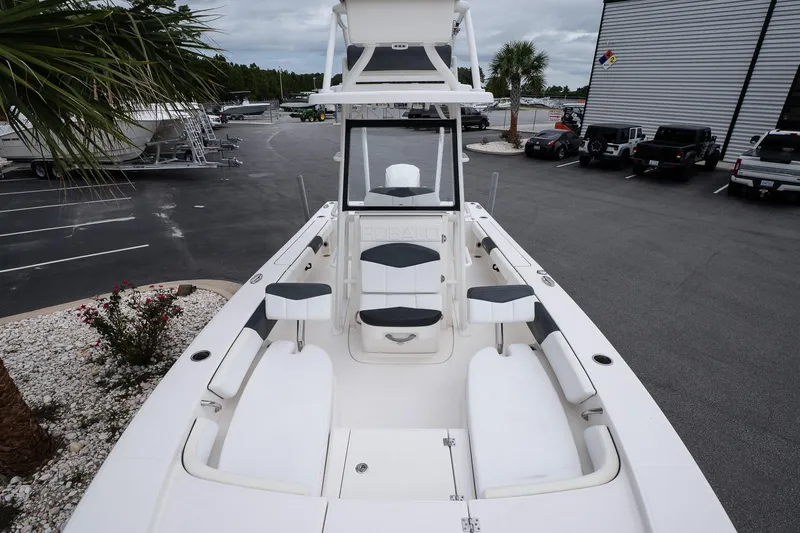 Slide: The Image of 2019 Robalo 246 Cayman SD boat with spacious seating, docked in a marina. - 32