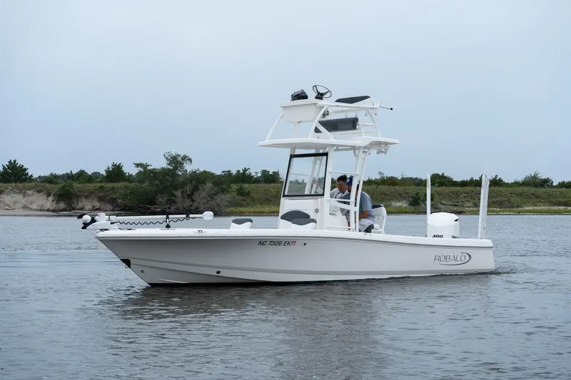 Slide: The Image of 2019 Robalo 246 Cayman SD boat on calm water, side view. - 6