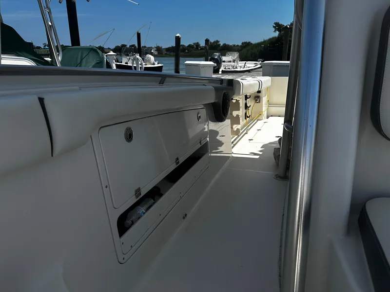 Slide: The Image of 2007 Robalo R300 Center Console boat interior with storage compartments and seating. - 11