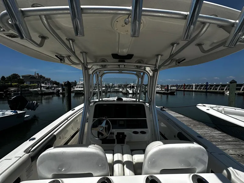 Slide: The Image of 2007 Robalo R300 Center Console boat docked at marina, clear sky background. - 12
