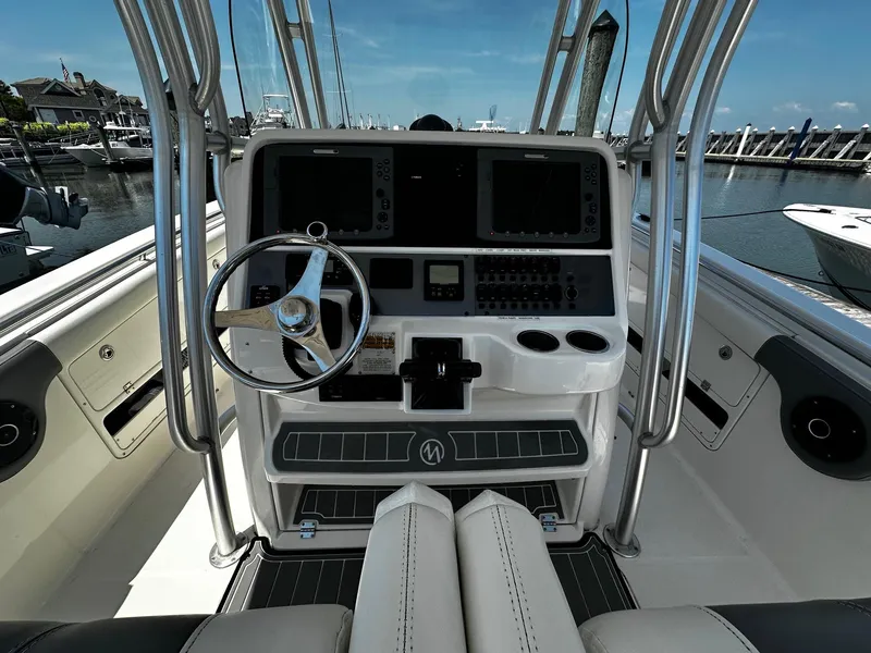 Slide: The Image of 2007 Robalo R300 Center Console boat dashboard with steering wheel and navigation controls. - 13
