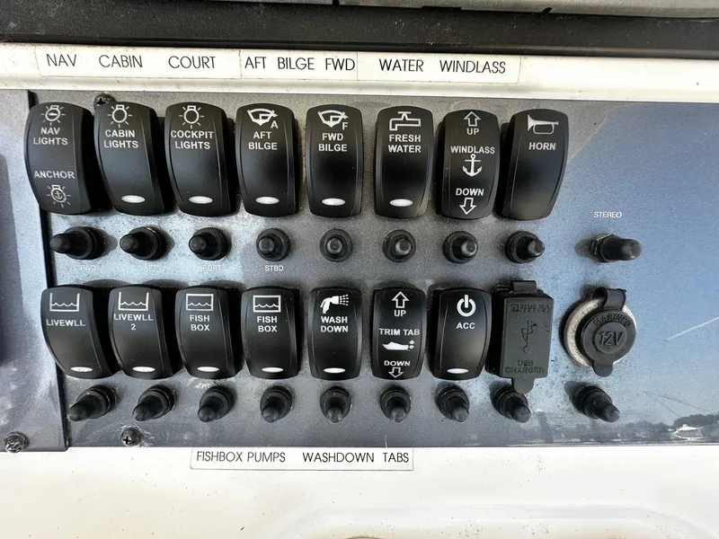 Slide: The Image of Control panel of a 2007 Robalo R300 Center Console boat with various switches and labels. - 15