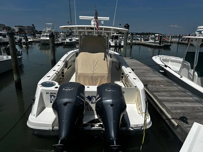 Slide: The Image of 2007 Robalo R300 Center Console boat docked at marina with twin outboard engines. - 2