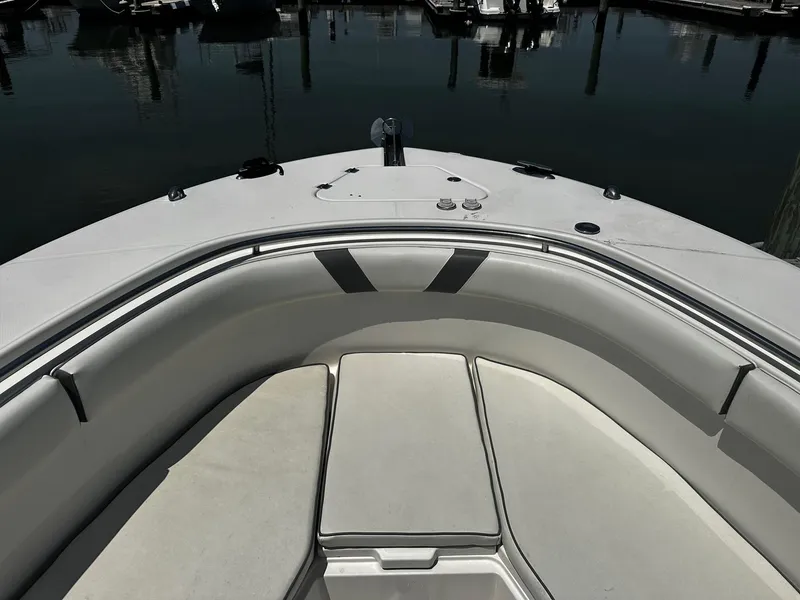 Slide: The Image of 2007 Robalo R300 Center Console boat interior with cushioned seating at the bow. - 3