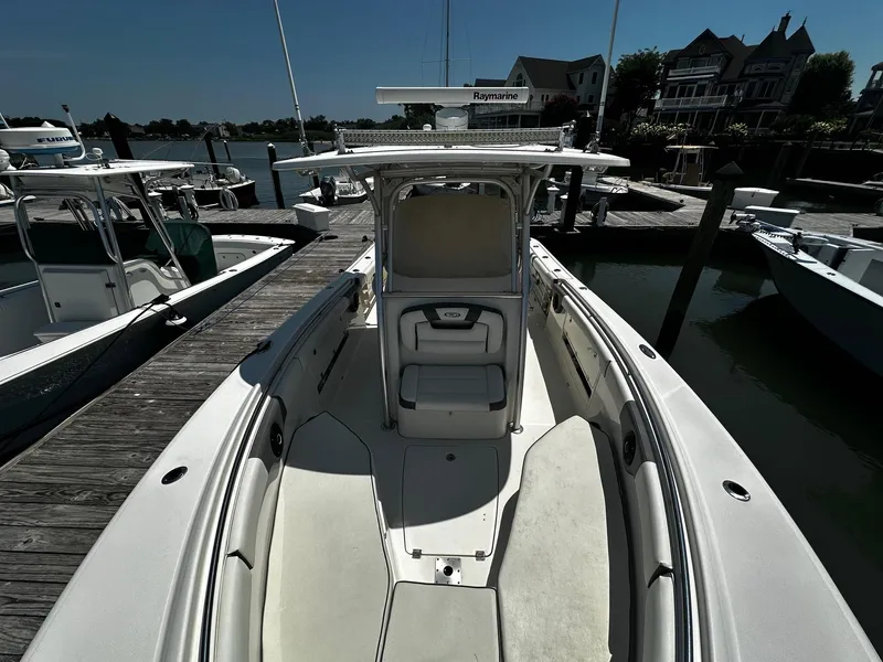 Slide: The Image of 2007 Robalo R300 Center Console boat docked at marina, showcasing spacious deck and seating. - 5