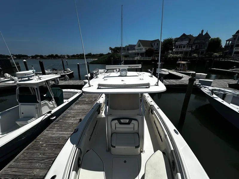 Slide: The Image of 2007 Robalo R300 Center Console boat docked at a marina, surrounded by other boats. - 7