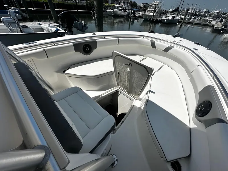 Slide: The Image of 2007 Robalo R300 Center Console boat interior with open storage compartment at marina. - 8