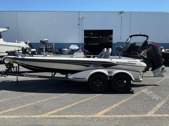 The Image of 2026 Ranger Z519R boat with trailer, parked outdoors near a warehouse. - 0