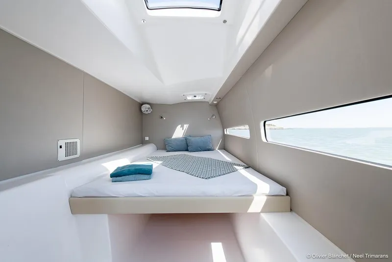 Slide: The Image of Modern cabin interior of NEEL 47, 2025 model, featuring a cozy bed and ocean view. - 10