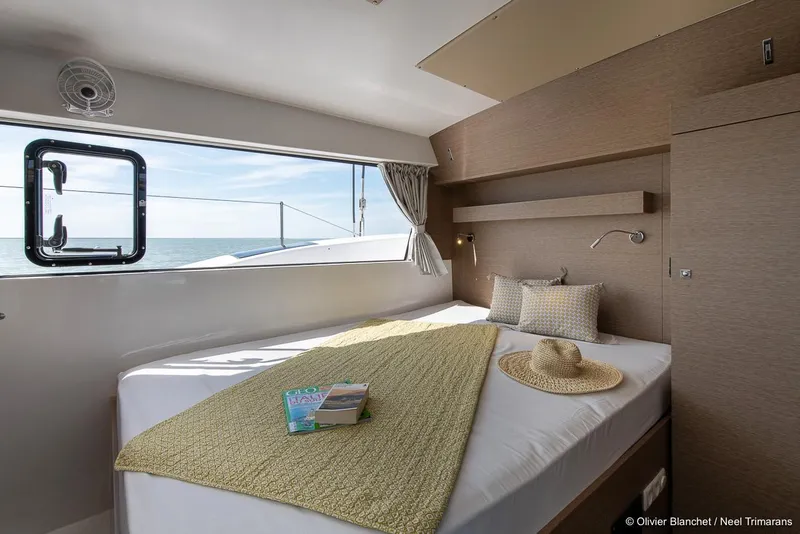 Slide: The Image of Cozy cabin interior of 2025 NEEL 47 trimaran with ocean view and stylish decor. - 13