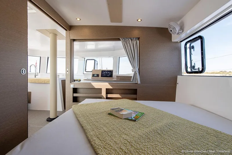 Slide: The Image of Interior of 2025 NEEL 47 trimaran, featuring a cozy bedroom with modern design. - 14