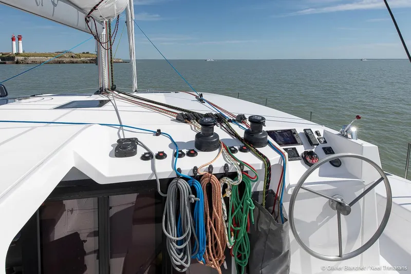 Slide: The Image of Sailing yacht NEEL 47, 2025 model, with ropes and steering wheel, on open sea. - 14