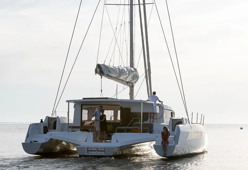 Slide: The Image of 2025 NEEL 47 trimaran sailing on calm waters at sunset. - 3