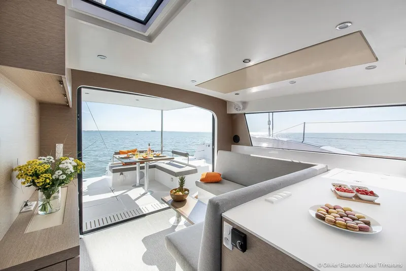 Slide: The Image of Luxurious interior of 2025 NEEL 47 yacht with ocean view, featuring elegant seating and dining area. - 5