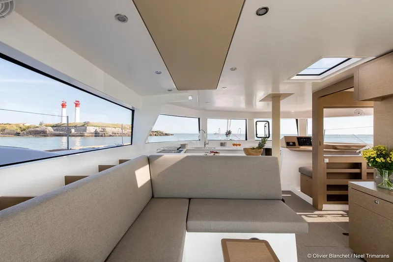 Slide: The Image of Modern interior of NEEL 47 trimaran, featuring spacious seating and panoramic windows, 2025 model. - 7