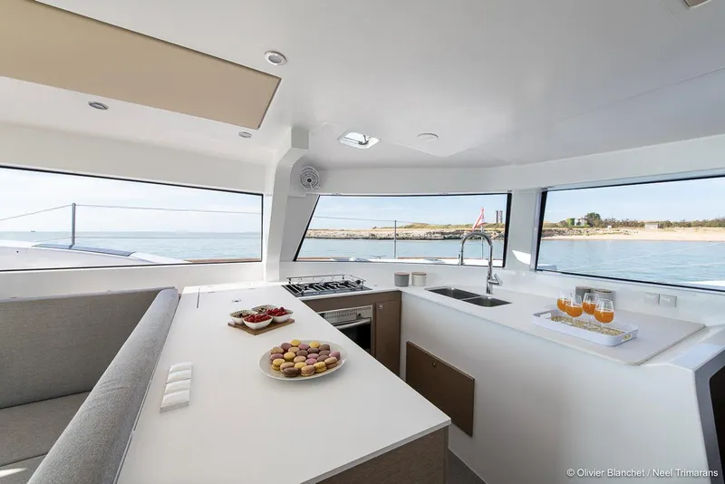 Slide: The Image of Modern NEEL 47 yacht interior with kitchen, panoramic windows, and ocean view, 2025 model. - 8