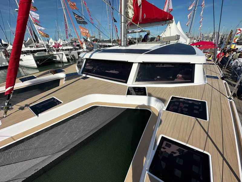 Slide: The Image of 2025 NEEL 52 trimaran at a boat show, showcasing sleek design and modern features. - 1