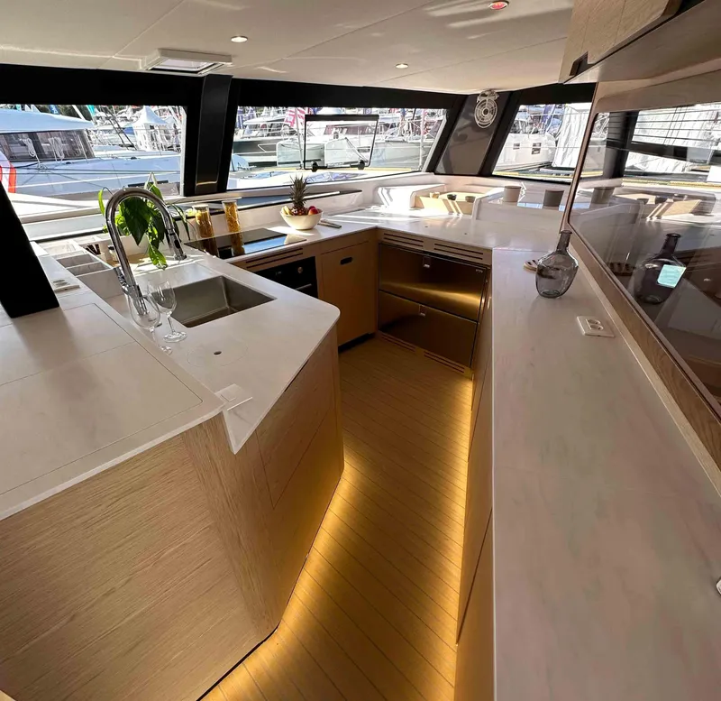 Slide: The Image of Luxurious NEEL 52 yacht interior kitchen with modern design and ambient lighting, 2025 model. - 14