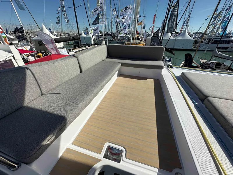 Slide: The Image of Spacious deck seating on 2025 NEEL 52 trimaran at a boat show. - 8