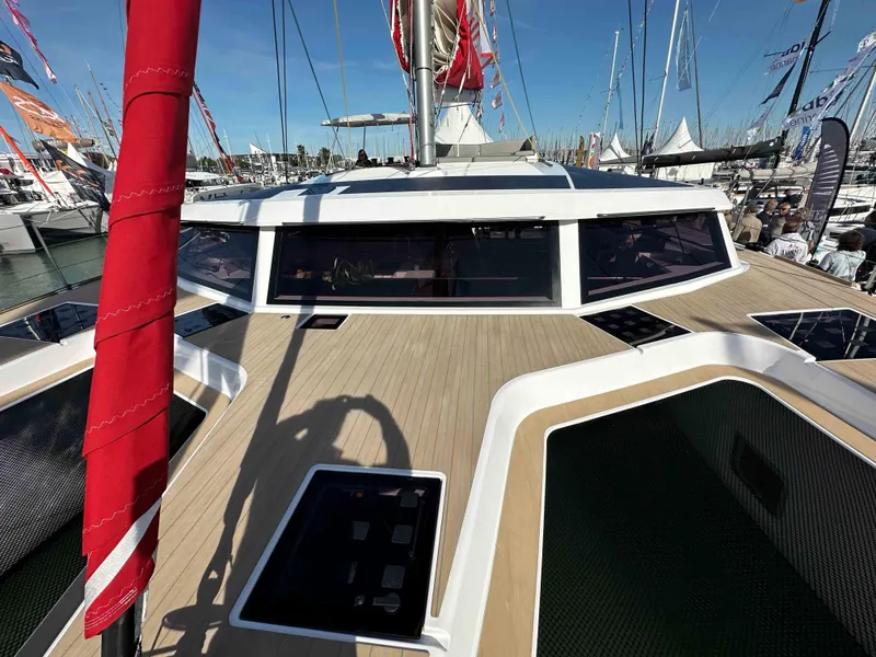 Slide: The Image of 2025 NEEL 52 Hybrid trimaran with sleek deck design at a boat show. - 3