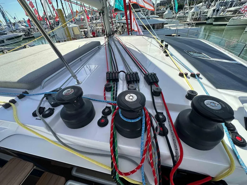 Slide: The Image of Deck of NEEL 52 Hybrid 2025 with colorful ropes and winches at a marina. - 4
