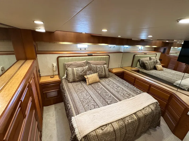 Slide: The Image of Luxurious bedroom interior of 2000 Offshore Yachts Pilothouse with elegant bedding and wood accents. - 12