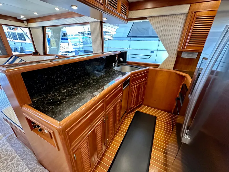 Slide: The Image of Luxurious 2000 Offshore Yachts Pilothouse interior with sleek kitchen and modern amenities. - 9