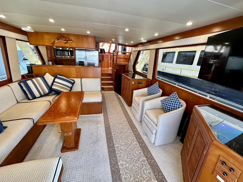 Slide: The Image of Luxurious 2000 Offshore Yachts Pilothouse interior with elegant seating, wooden accents, and modern amenities. - 11