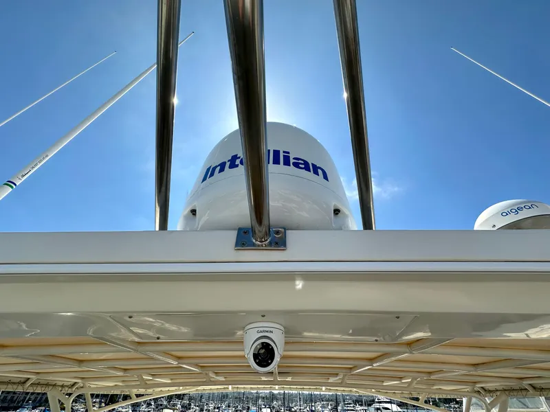 Slide: The Image of 2000 Offshore Yachts Pilothouse with Intellian satellite system under clear blue sky. - 18