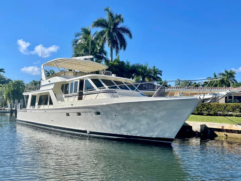 Slide: The Image of 2000 Offshore Yachts Pilothouse in a sunny marina with palm trees. - 2