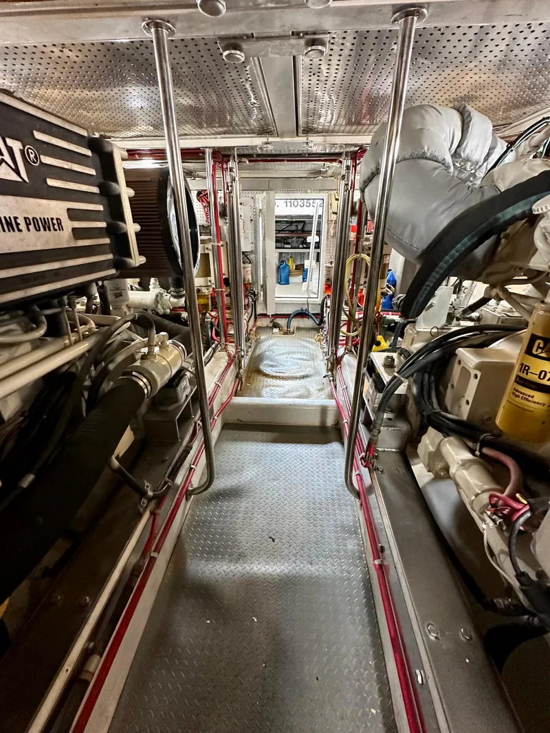 Slide: The Image of Engine room of a 2000 Offshore Yachts Pilothouse, showcasing machinery and equipment. - 21