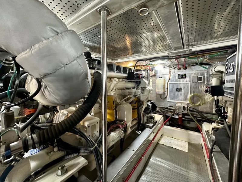Slide: The Image of Engine room of 2000 Offshore Yachts Pilothouse, showcasing mechanical components and systems. - 23