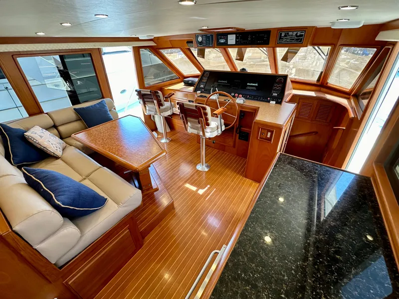 Slide: The Image of Luxurious 2000 Offshore Yachts Pilothouse interior with plush seating and modern helm. - 4