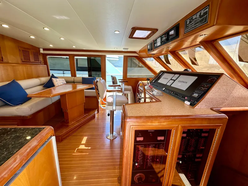 Slide: The Image of Luxurious interior of a 2000 Offshore Yachts Pilothouse, featuring wood finishes and modern navigation equipment. - 7
