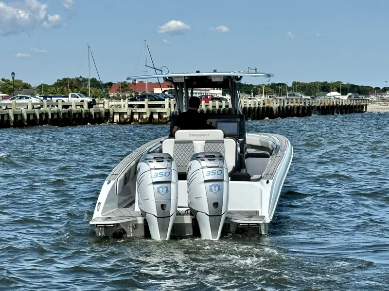 Slide: The Image of 2019 Statement 350 Open boat with dual engines on water near dock. - 4