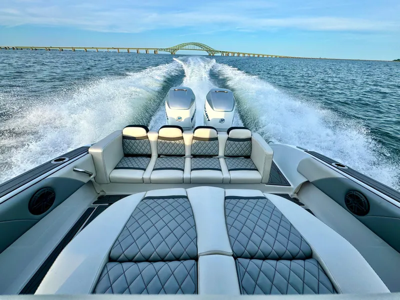 Slide: The Image of Luxury 2019 Statement 350 Open boat cruising with twin engines, bridge in background. - 8