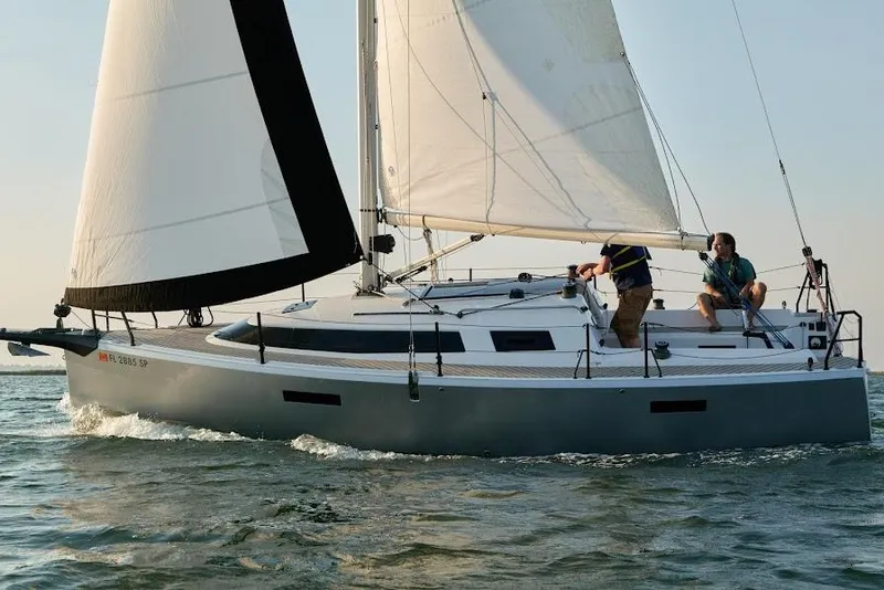 The Image of 2025 Faro Yachts 29 sailing on open water with two people onboard. - 0