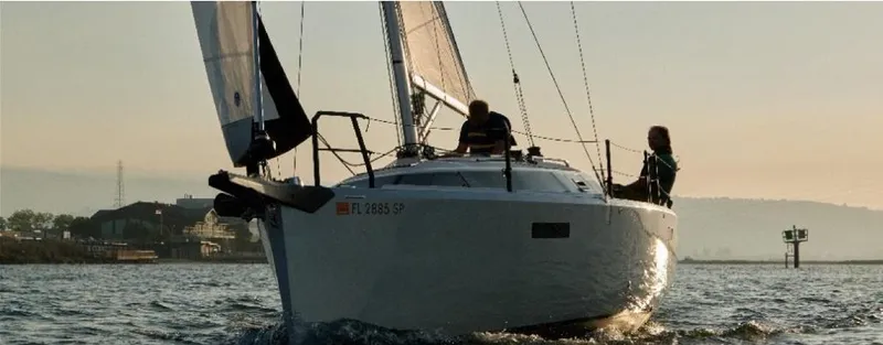 Slide: The Image of 2025 Faro Yachts 29 sailing on calm waters at sunset. - 1