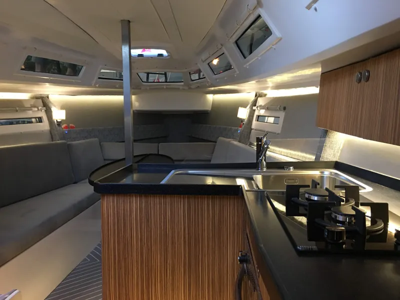 Slide: The Image of Luxurious interior of 2025 Faro Yachts 29, featuring modern kitchen and seating area. - 11