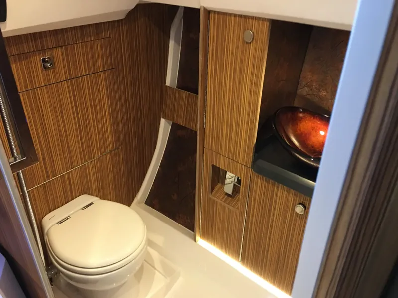 Slide: The Image of Luxurious bathroom interior of 2025 Faro Yachts 29, featuring wood paneling and modern fixtures. - 13