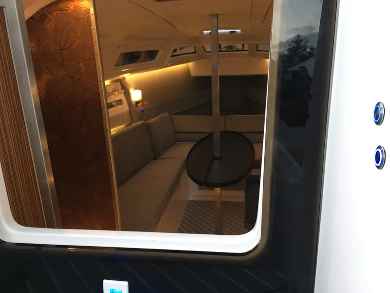 Slide: The Image of Interior view of 2025 Faro Yachts 29, featuring modern seating and ambient lighting. - 15