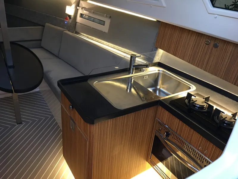 Slide: The Image of Modern kitchen interior of 2025 Faro Yachts 29, featuring sleek design and amenities. - 16